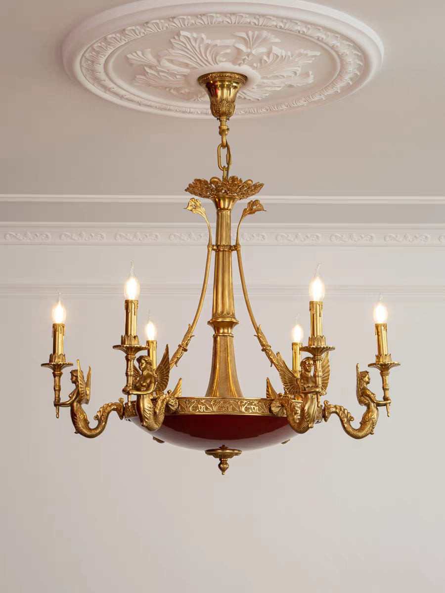 Gold chandelier with multiple lights on a white wall