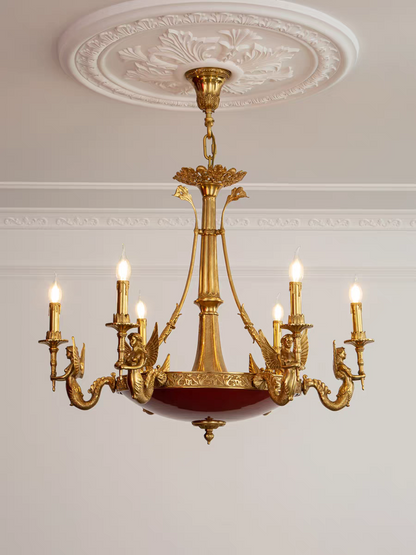 Gold chandelier with multiple lights on a white wall