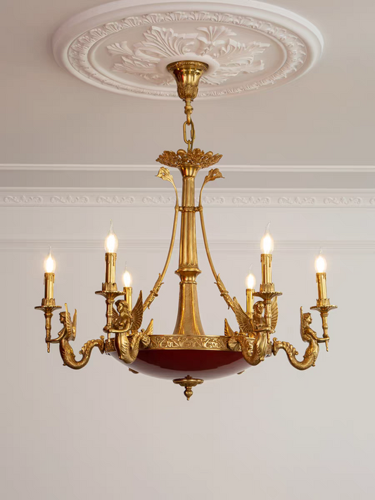 Gold chandelier with multiple lights on a white wall